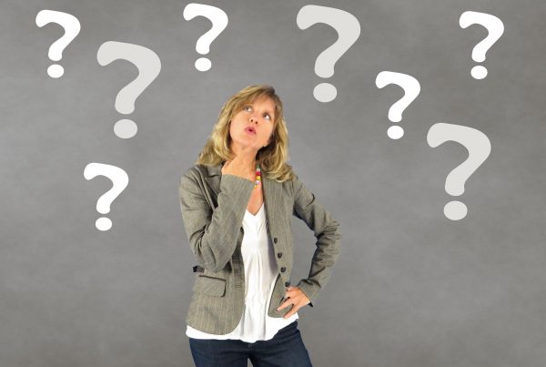 a woman thinking in Infront of a grey background
