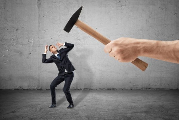 a business man under the hammer