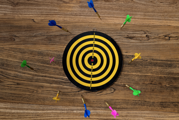 A dart board surrounded by darts